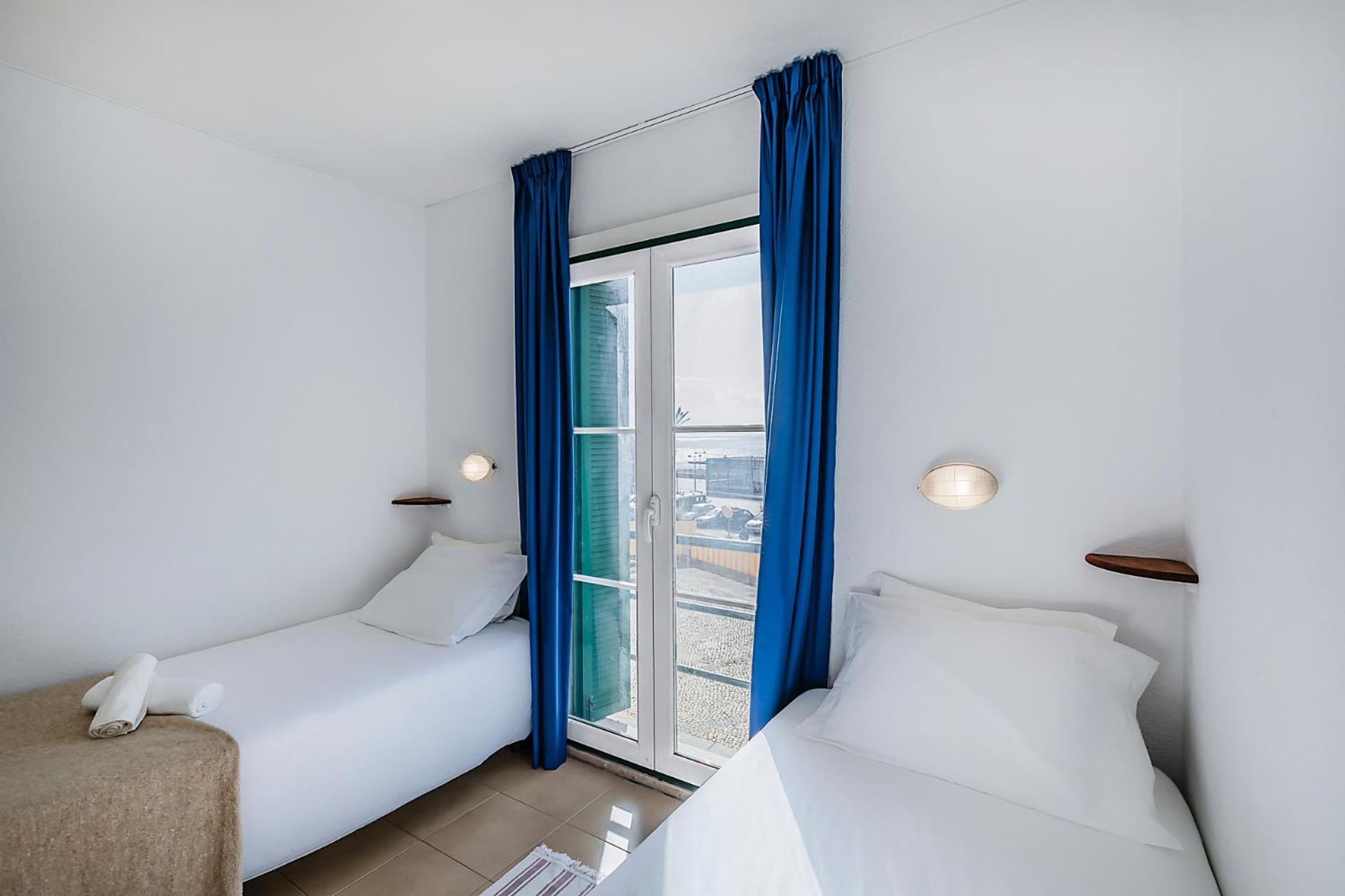 Quarto com 2 Camas de Solteiro e Banheiro Compartilhado